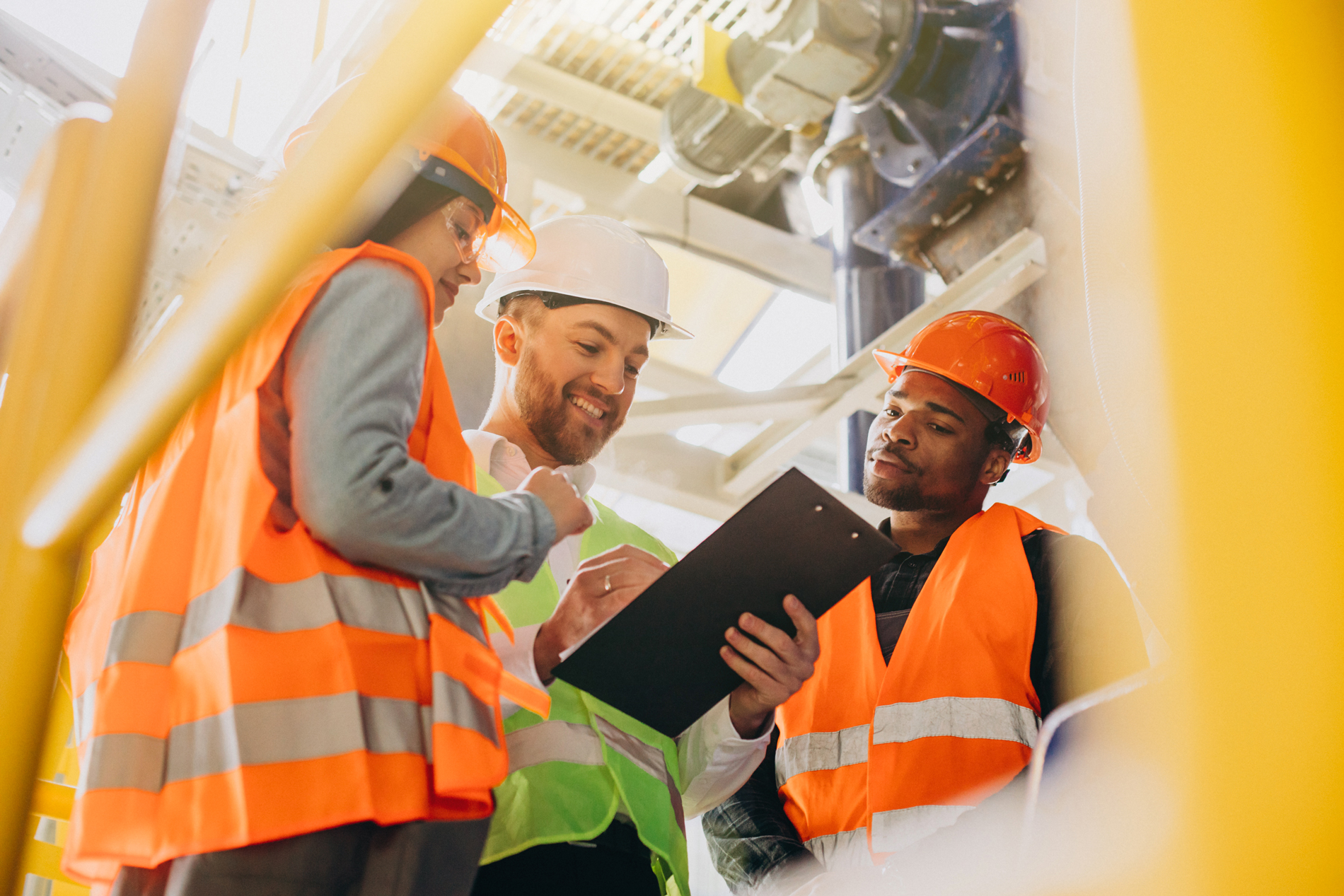 two construction apprentices listen as leader explains plan