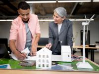Image of older professional female and young professional male planning for alternative energies