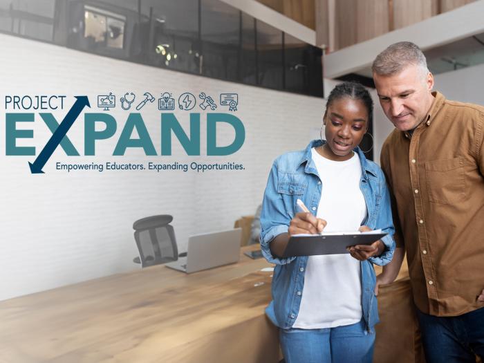 Project EXPAND logo overlayed on photo of high school aged female showing information on a tablet to a professional male in a conference room setting